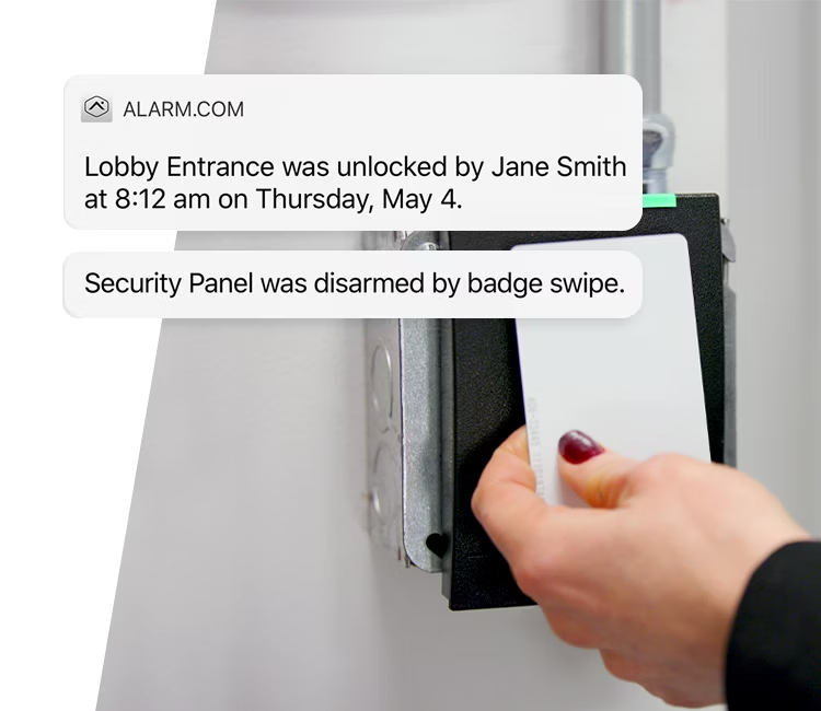 A person swiping an access card to unlock a secure door, with Alarm.com&rsquo;s real-time notification system highlighting access details for enhanced security monitoring.