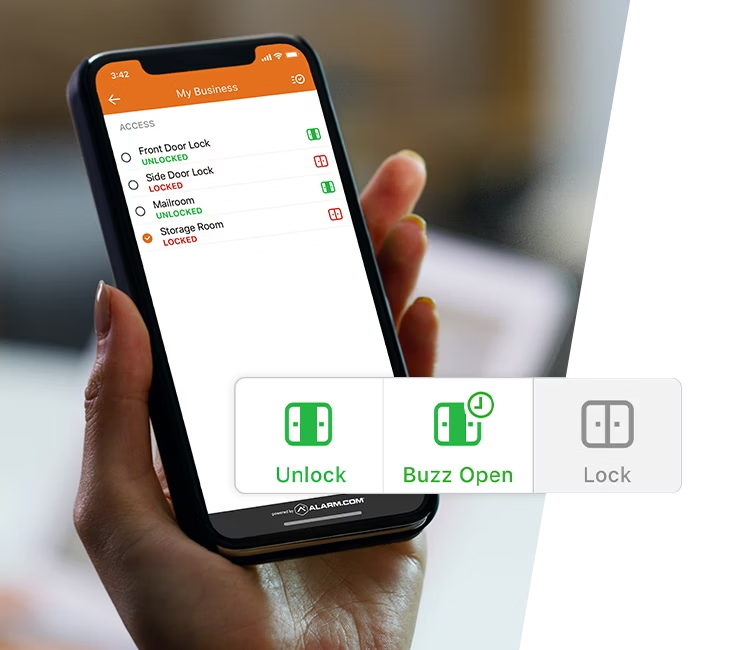 A hand holding a smartphone displaying Alarm.com&rsquo;s business lock control interface, featuring options to unlock, lock, or buzz open secure doors remotely.