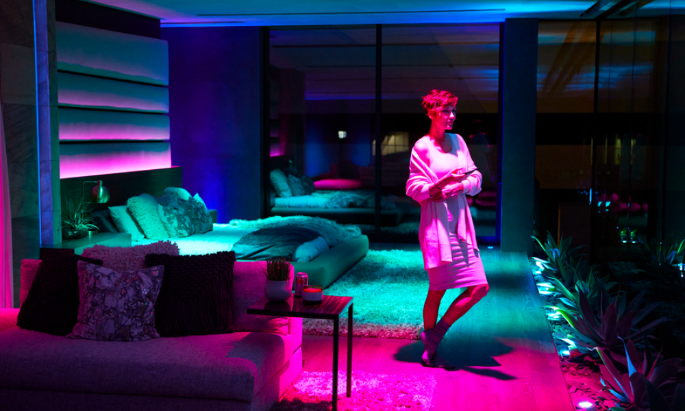 <span class="uk-h4">A woman is pictured in a luxury condominium with colorful mood lighting.</span>