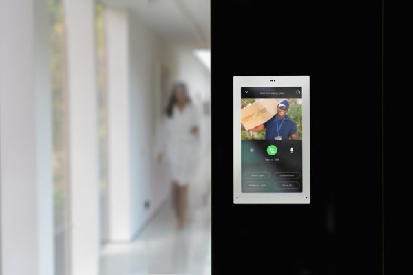 Savant wall-mounted touchscreen shows surveillance footage from a patio&rsquo;s video doorbell.