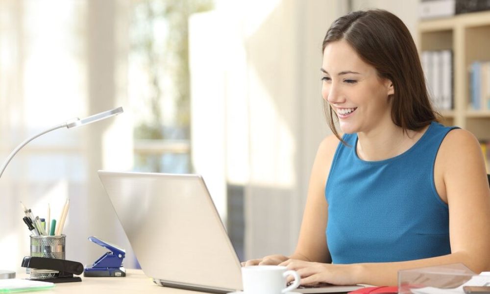<span class="uk-h4">A woman at her desk using her laptop with a home network.</span>