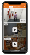 A mobile device displaying the Alarm.com app&rsquo;s live video monitoring feature, highlighting security camera feeds for a business.